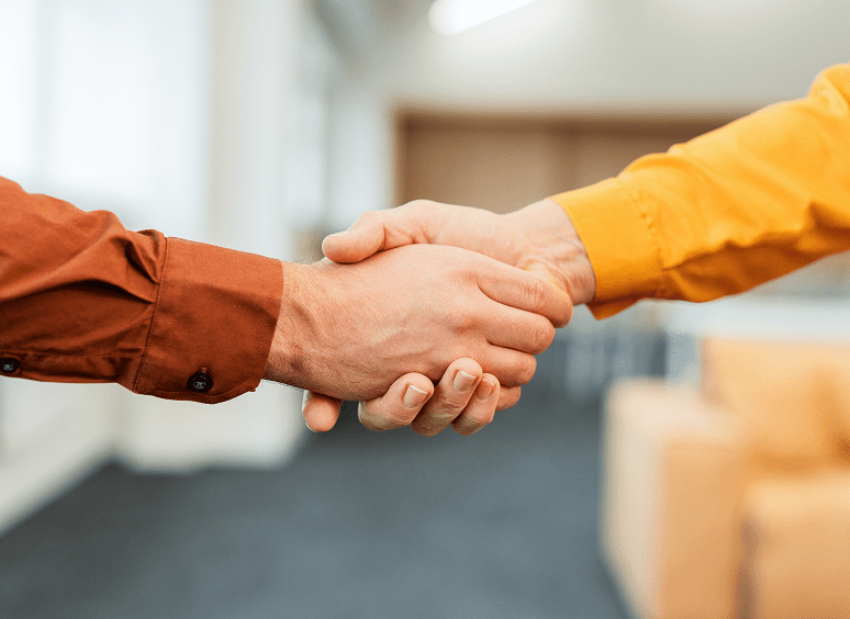 Two people shaking hands in agreement.